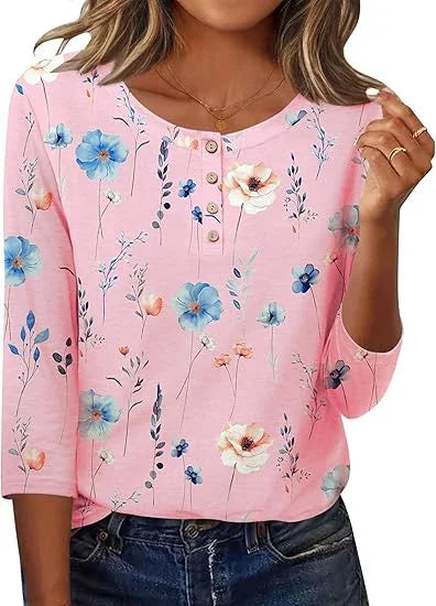 Woman wearing pink floral print buttoned top with three-quarter sleeves and blue jeans