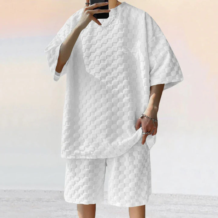 Person wearing white textured checkerboard pattern oversized t-shirt and shorts set