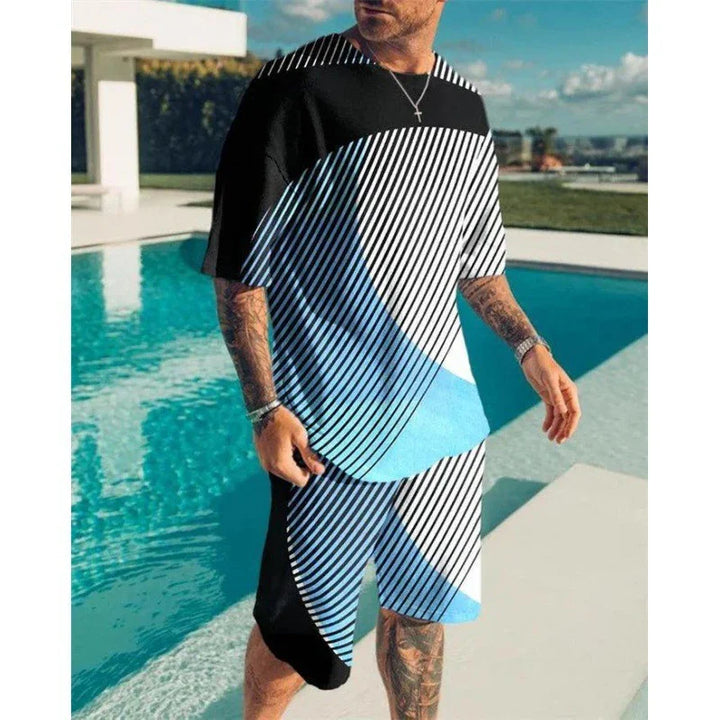 man wearing black and blue geometric striped matching t-shirt and shorts standing by outdoor pool