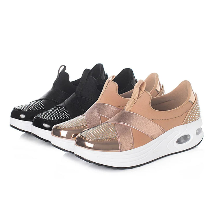 Pair of stylish slip-on platform sneakers in rose gold and black with metallic and rhinestone details