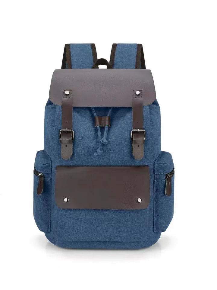 Blue canvas backpack with brown leather flap, front pocket and side zipper pockets