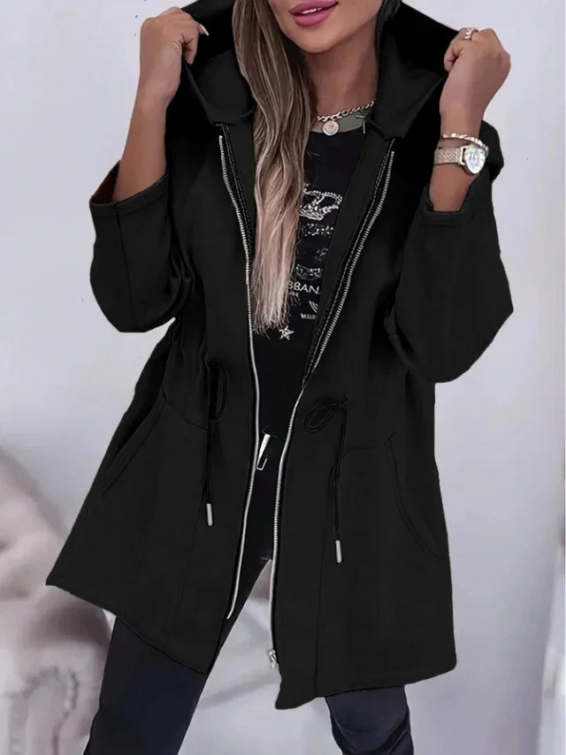 woman wearing black zip-up hooded jacket with drawstrings, long sleeves, and front pockets