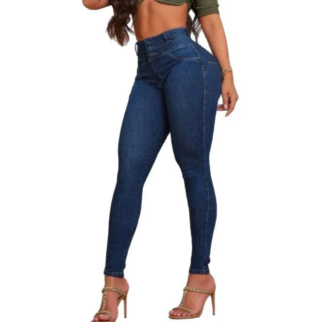 woman wearing high-waisted dark blue skinny jeans with gold chain high heels