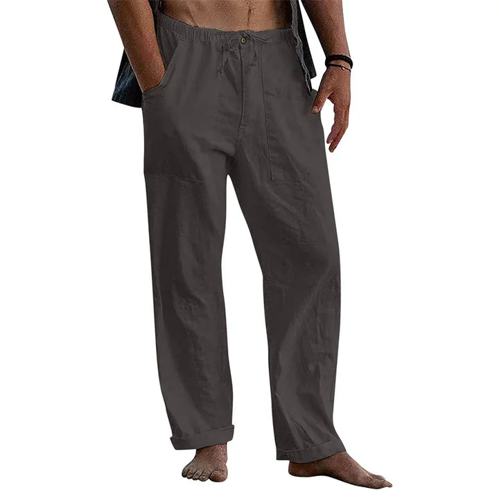 Men's casual loose-fit dark gray cotton pants with pockets, rolled cuffs, and elastic waistband