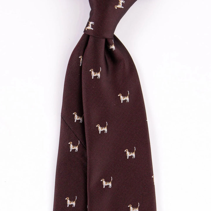 Brown textured necktie with small embroidered dog pattern on white background