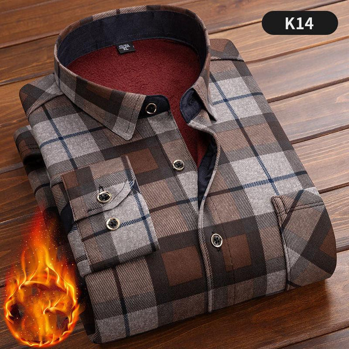 Folded brown and gray checkered flannel shirt with red fleece lining on wooden surface