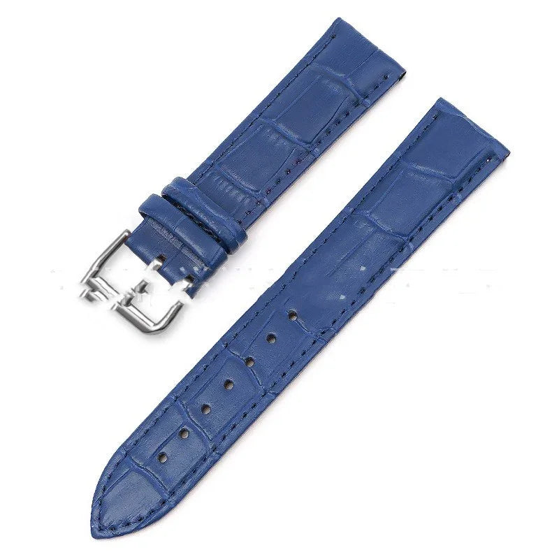 Blue leather watch strap with crocodile texture and silver buckle on white background