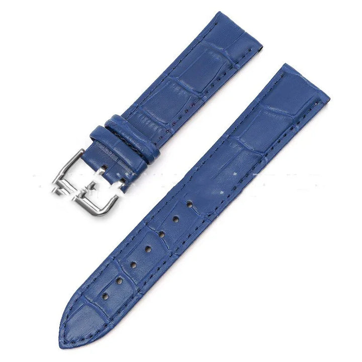 Blue leather watch strap with crocodile texture and silver buckle on white background