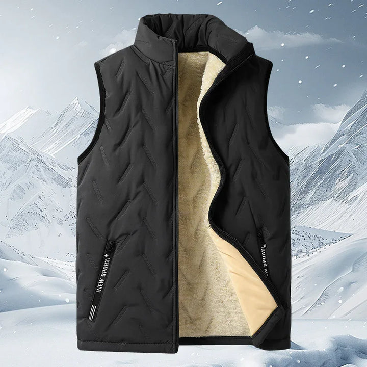 Black sleeveless winter vest with soft beige fleece lining and zippered pockets on snowy mountain background