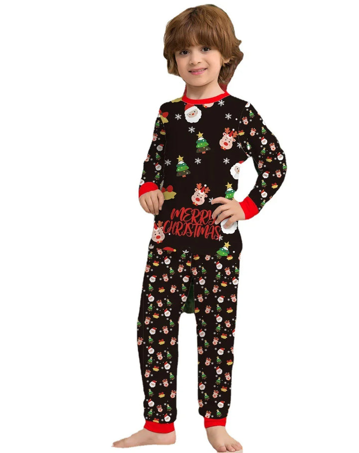 Child wearing black Christmas pajamas with Santa, reindeer, trees, and Merry Christmas text