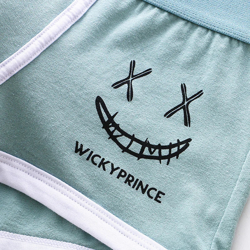 Light green fabric with black stitched smiley face and text WICKYPRINCE, white trim detail