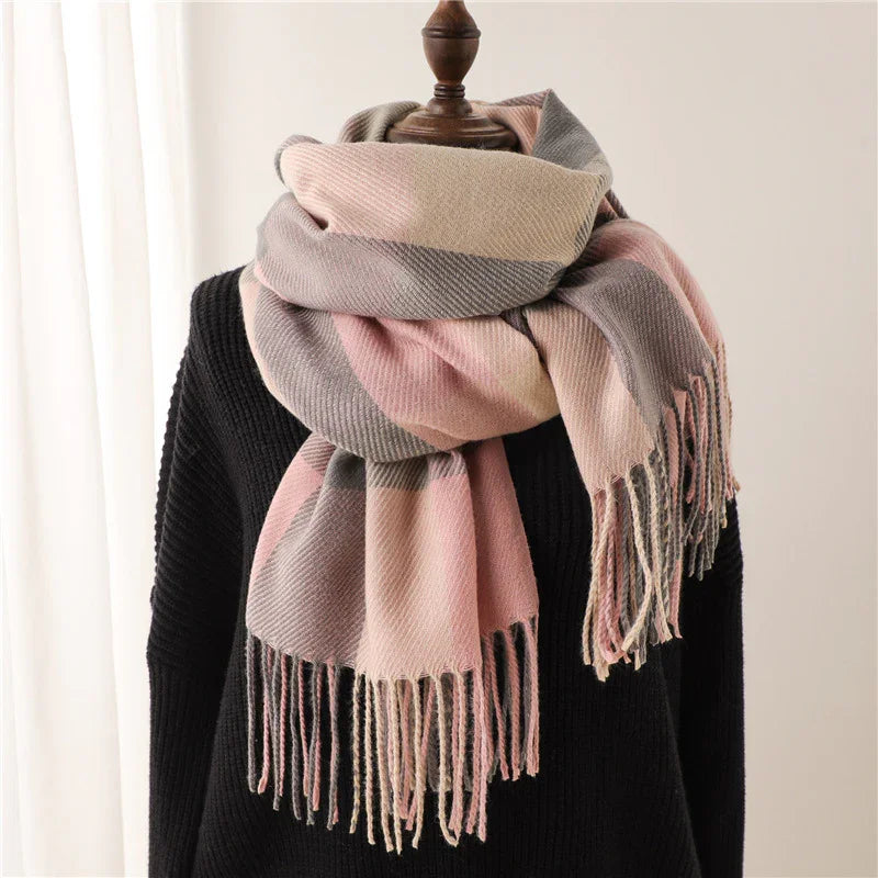 Soft pink and gray plaid wool scarf with fringes on black sweater display