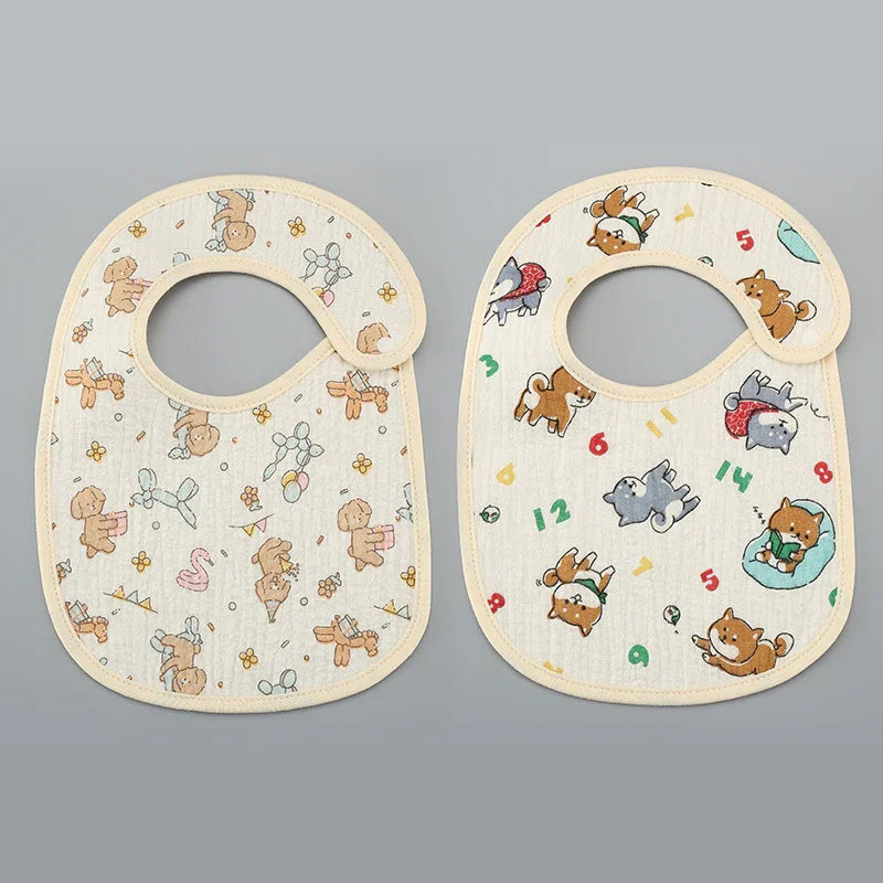 Two baby bibs with cartoon animal prints; left one with teddy bears and balloons, right one with playful dogs and numbers
