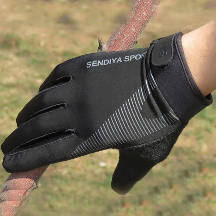 Black SENDIYA SPORT glove with gray stripes on hand holding a textured branch outdoors