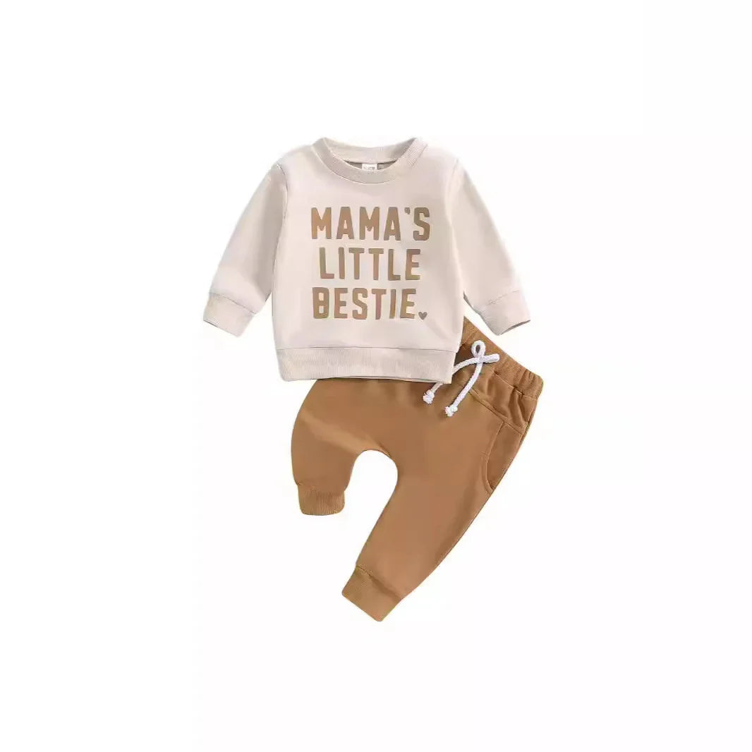 Toddler beige sweatshirt with text Mama's Little Bestie and brown cuffed pants with drawstring