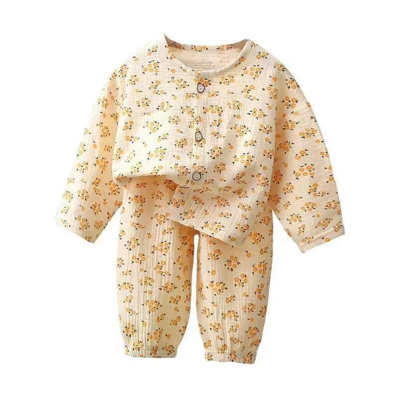 Baby romper set with long sleeves and pants, beige fabric with small yellow floral print, wooden buttons