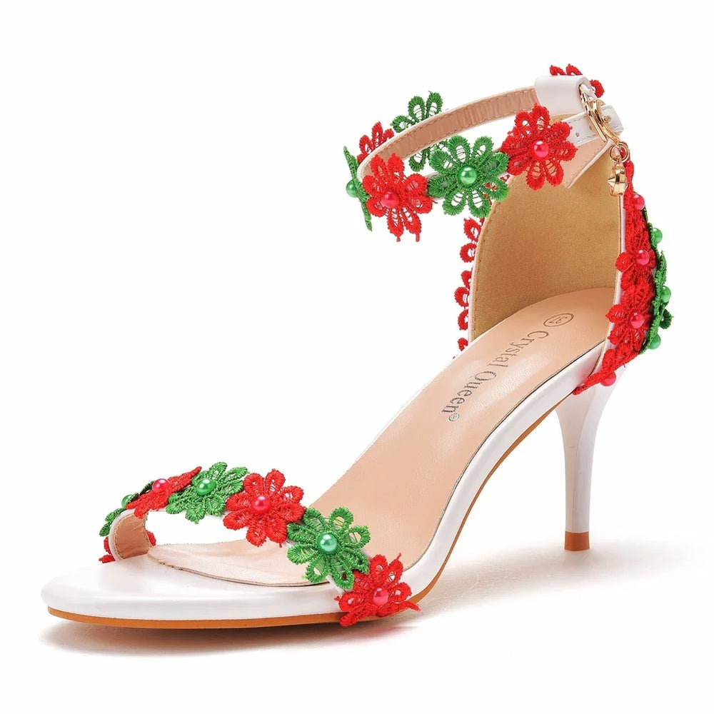 White high heel sandal with red and green floral lace decorations and pearl accents