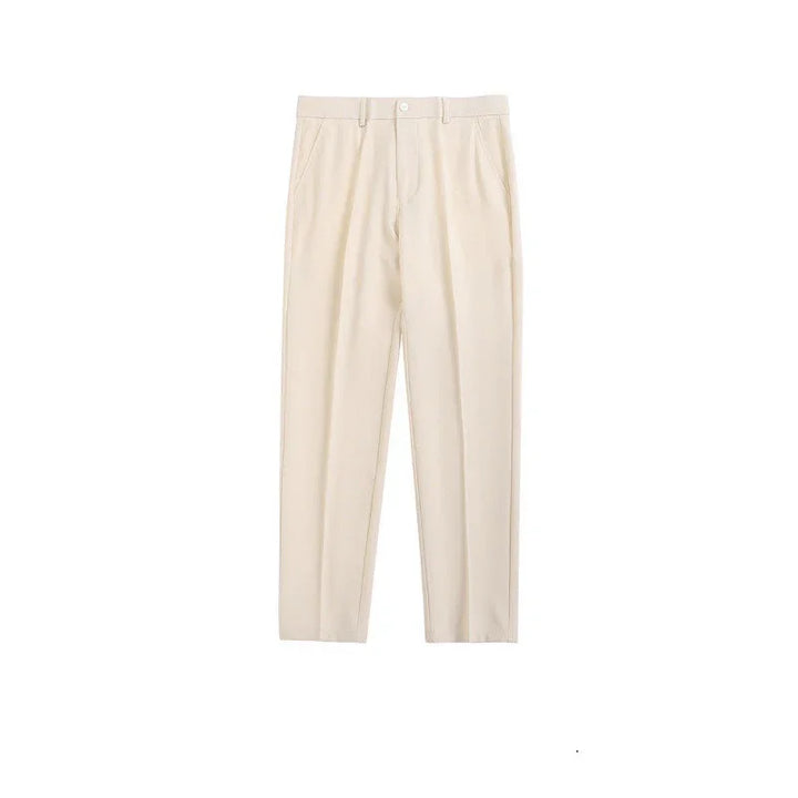 Beige tailored men's trousers with front pleats and side pockets on white background