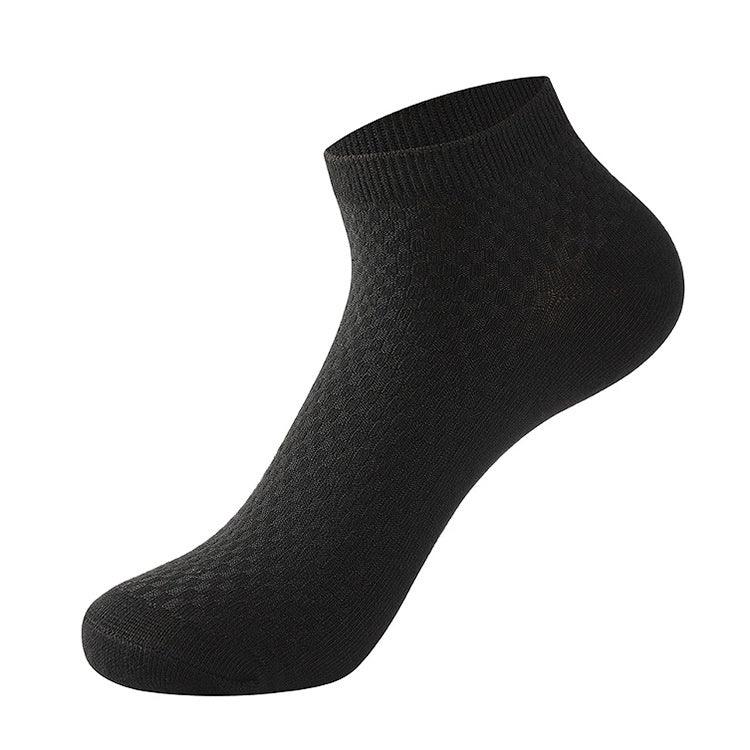 black ankle sock with textured knit pattern on white background