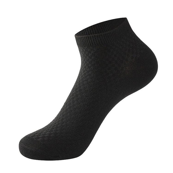 black ankle sock with textured knit pattern on white background