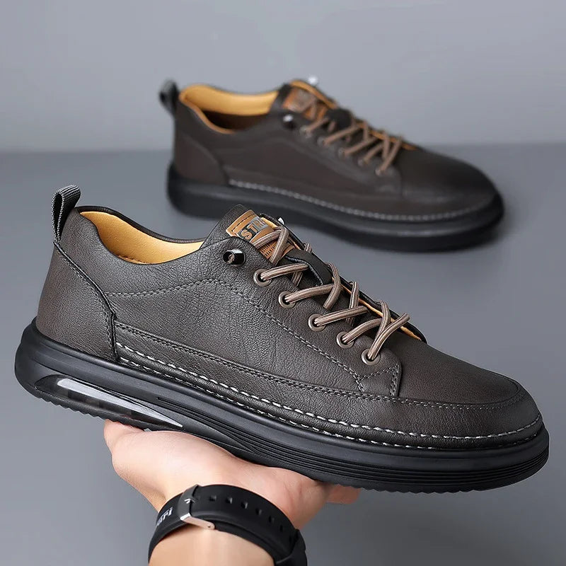 Close-up of stylish dark brown casual leather sneakers with black soles and beige interior lining