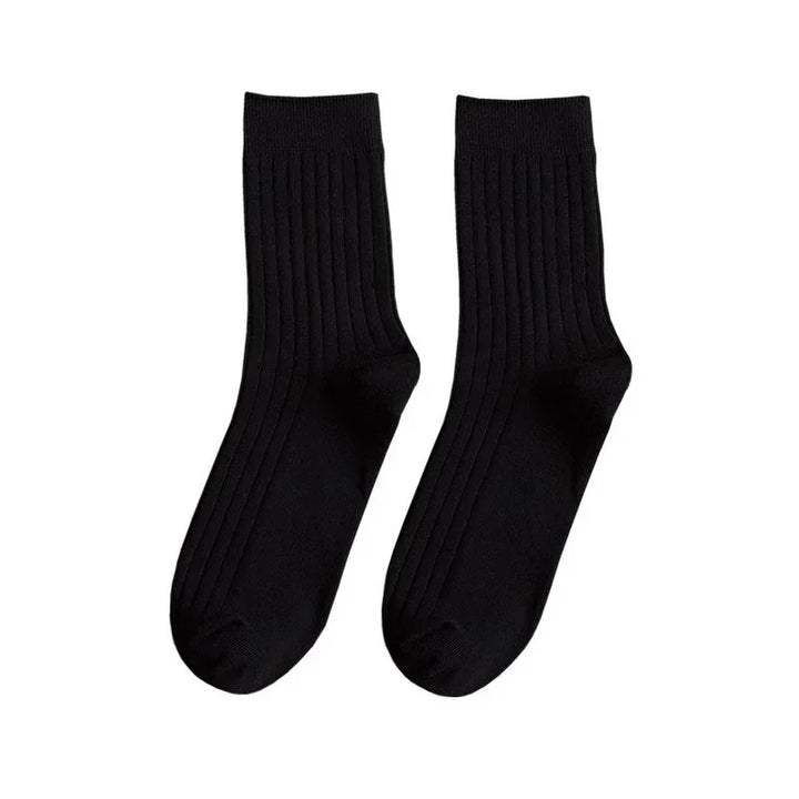 Pair of black ribbed crew socks on white background, comfortable cotton blend