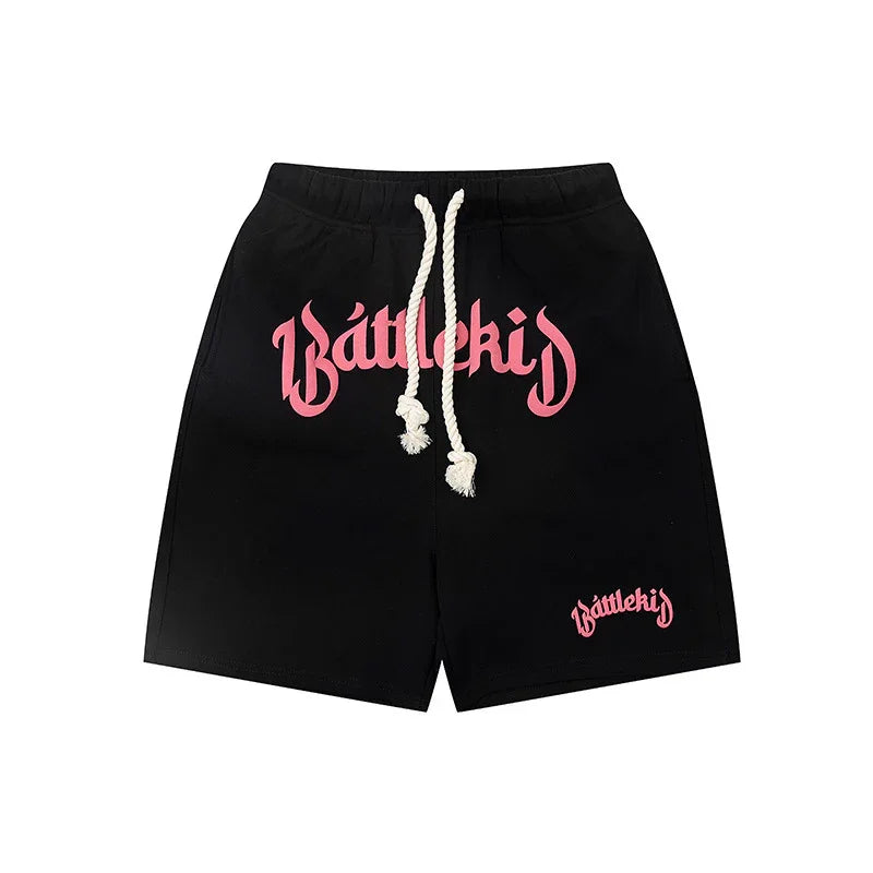 Black Battlekid shorts with pink logo and white drawstring on white background