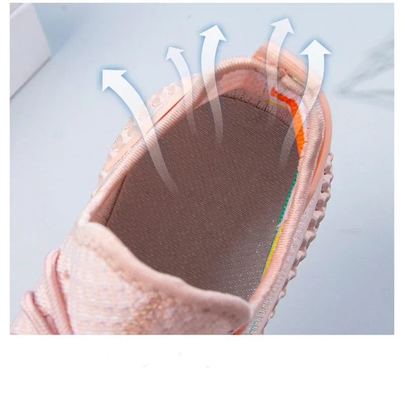 Close-up of breathable pink sneaker interior showing ventilation arrows for airflow