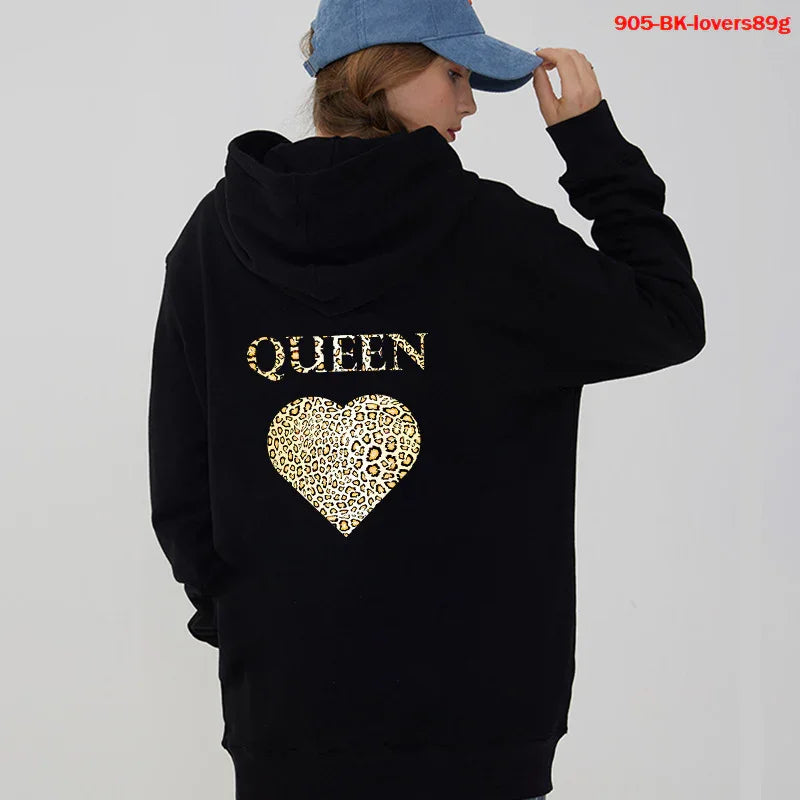 Woman wearing black hoodie with leopard print heart and queen text on back, blue cap