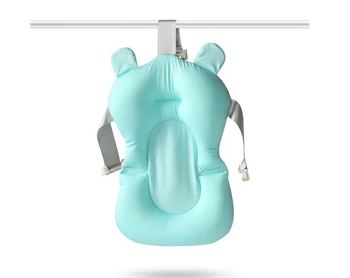 Light blue baby bath seat with head and side support hanging on a white rod with adjustable grey straps