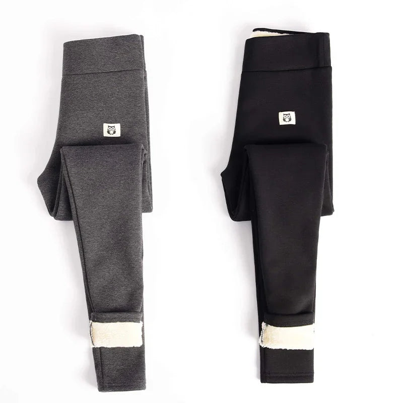 Folded grey and black fleece-lined leggings with small owl logo patches on white background