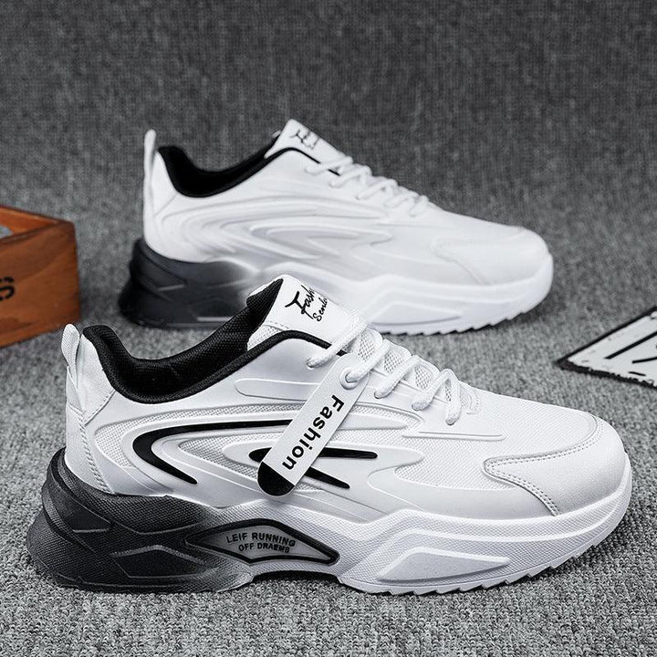 White and black casual sports sneakers with 'Fashion' tag on gray carpet background