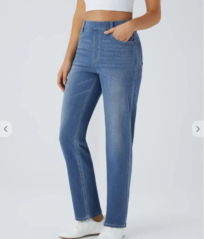 Woman wearing high-waisted straight-leg blue jeans with side pockets and white sneakers