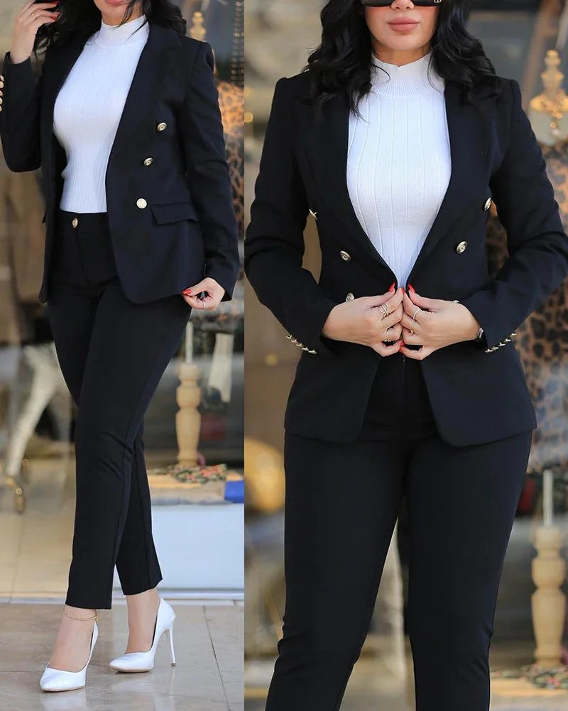 Woman wearing black double-breasted blazer with gold buttons, white ribbed turtleneck, black pants, and white high heels