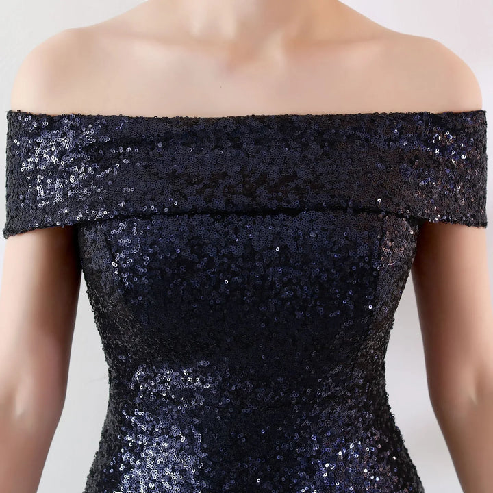 Close-up of off-shoulder black sequined evening dress on model torso