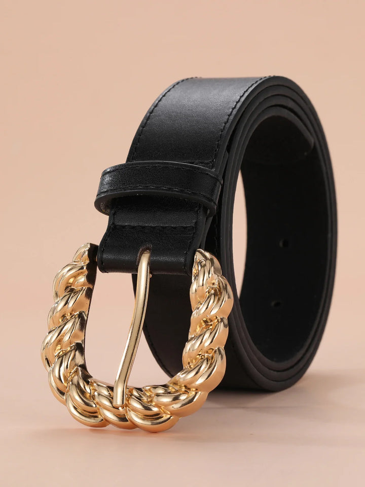 Black leather belt with a chunky twisted gold chain belt buckle on beige background