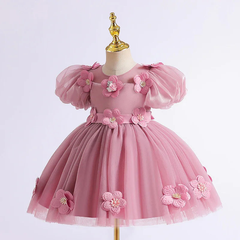 Pink toddler dress with puff sleeves and 3D floral appliques on skirt and bodice