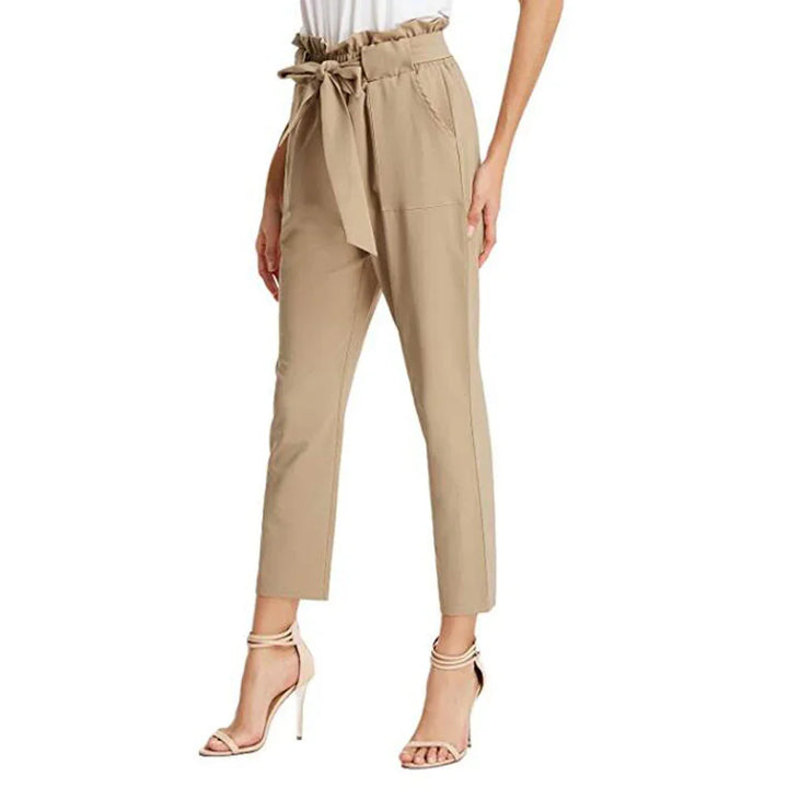 Women's beige paperbag waist pants with tie belt, paired with nude high heel sandals