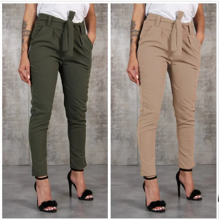 Women wearing high-waisted paperbag pants with belt in olive green and beige paired with black high heel sandals