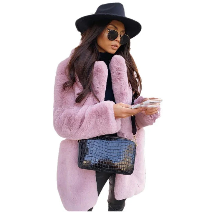 Fashionable woman in pink faux fur coat, black hat, sunglasses, and black croc leather handbag