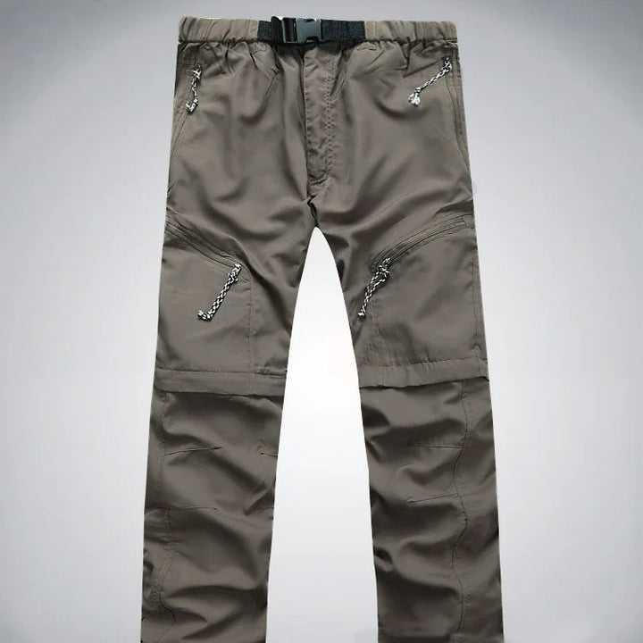 Men's gray outdoor hiking pants with multiple zip pockets and adjustable belt buckle