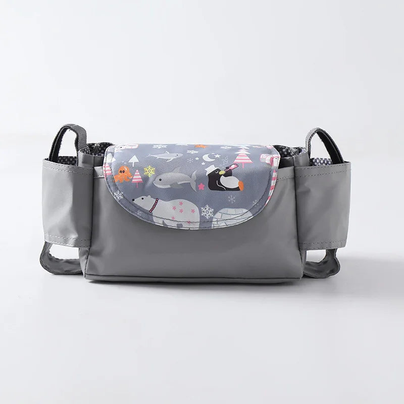 Gray baby stroller organizer with winter animal print flap including polar bears and penguins