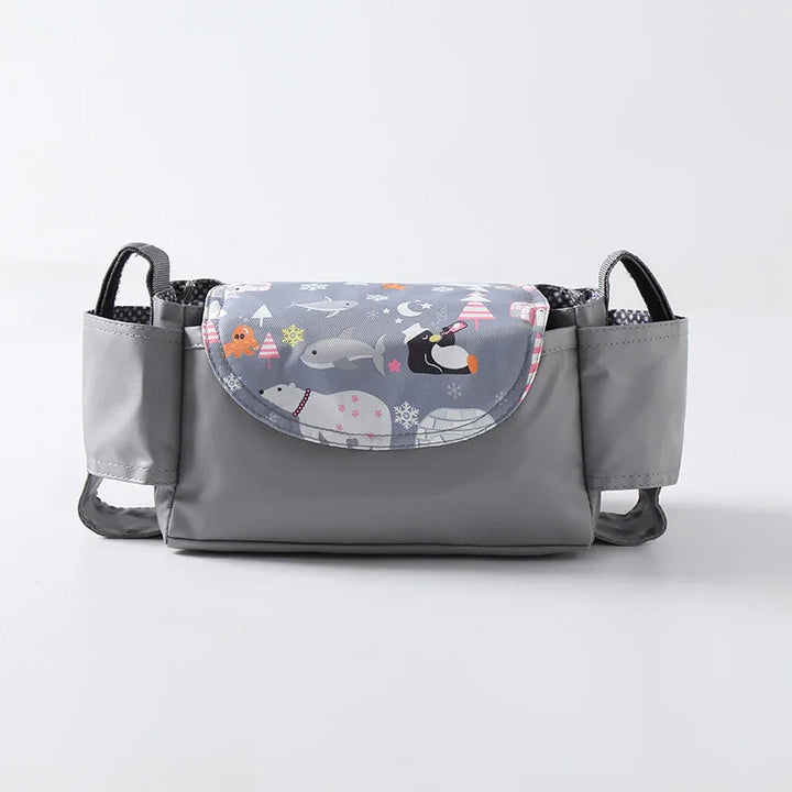 Gray baby stroller organizer with winter animal print flap including polar bears and penguins