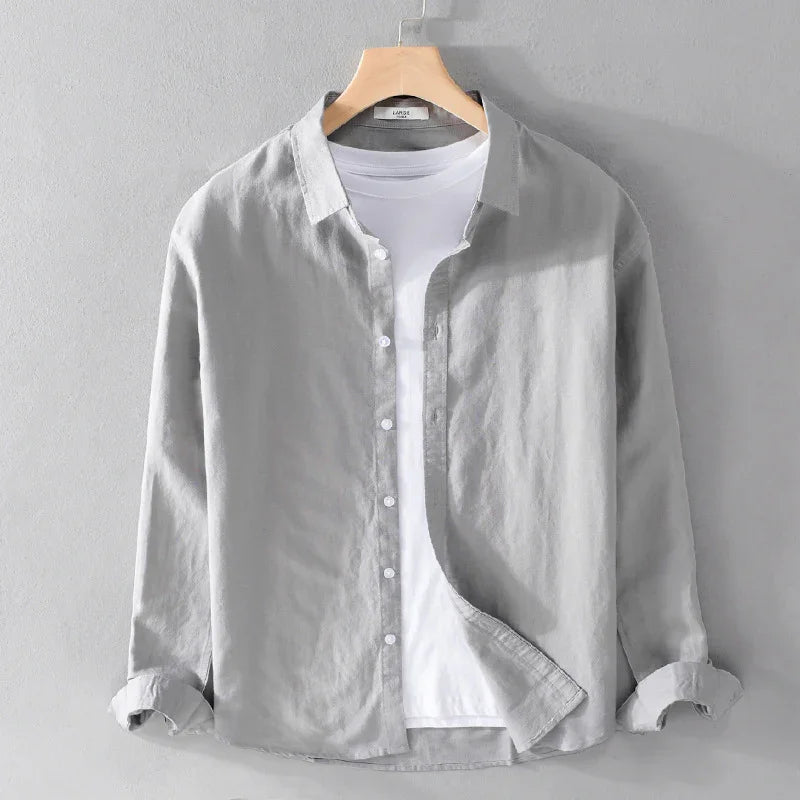 Light gray casual button-up shirt layered over a white crew neck t-shirt on a wooden hanger