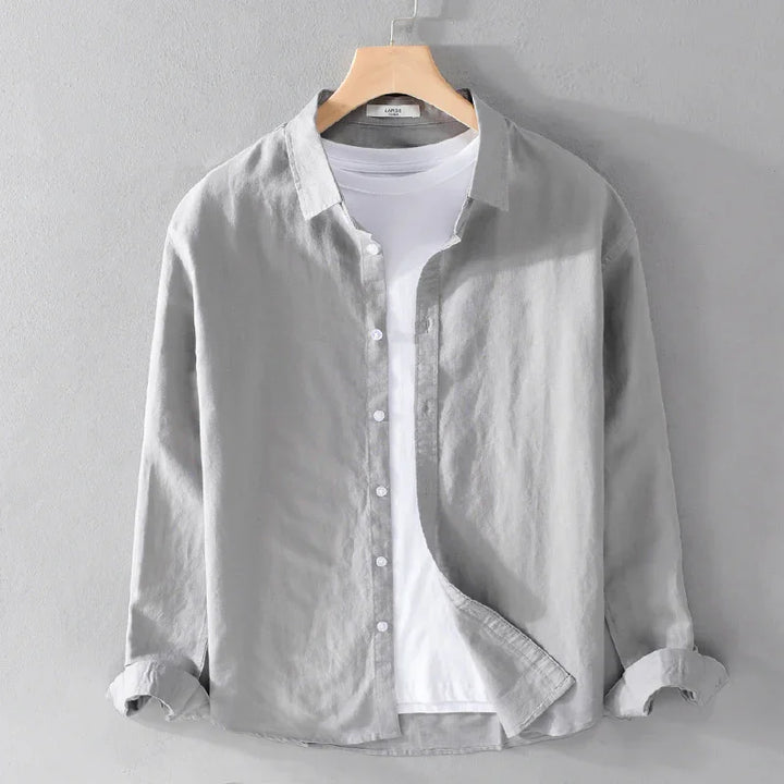Light gray casual button-up shirt layered over a white crew neck t-shirt on a wooden hanger