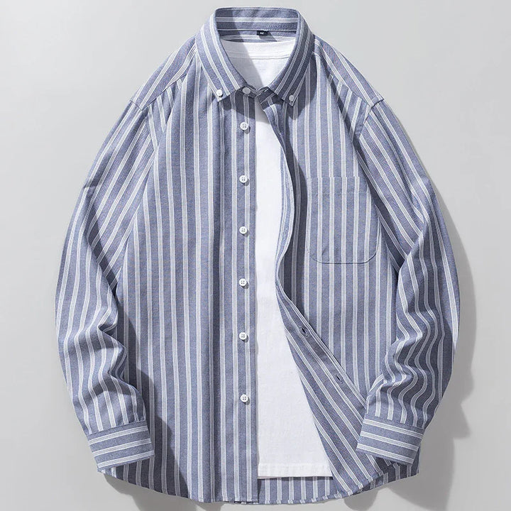 Blue and white vertical striped button-up shirt with chest pocket over white T-shirt