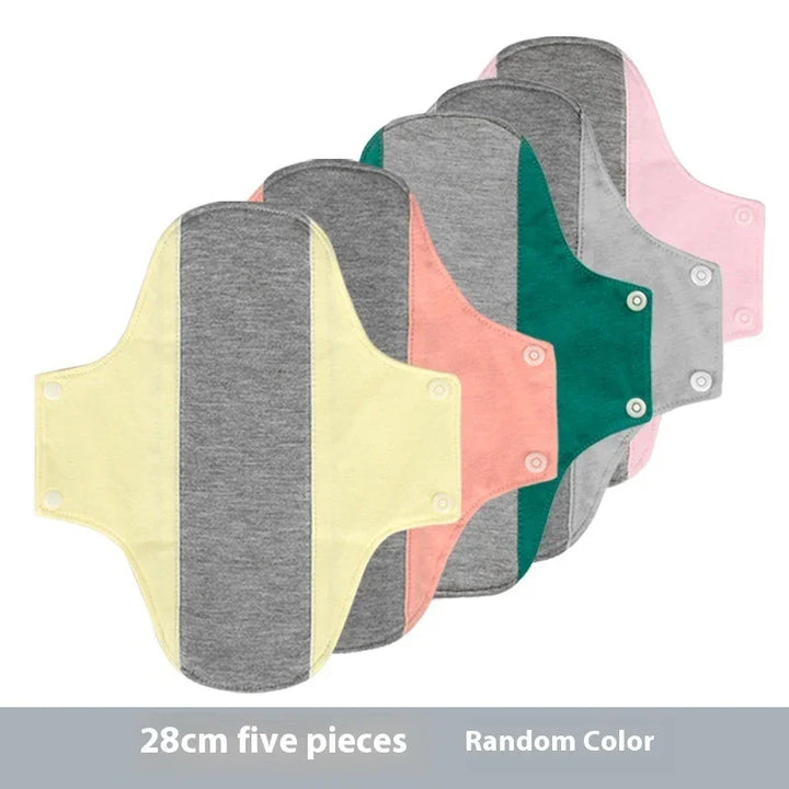 Set of five 28cm reusable cloth sanitary pads in assorted pastel and gray colors with snap closures
