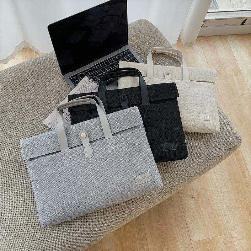 Three stylish laptop bags in gray, black, and beige on a beige ottoman next to an open laptop