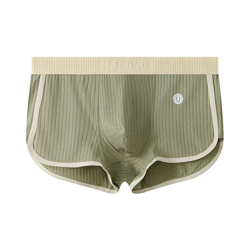 Green ribbed men's boxer briefs with beige waistband and trim, elastic logo waistband