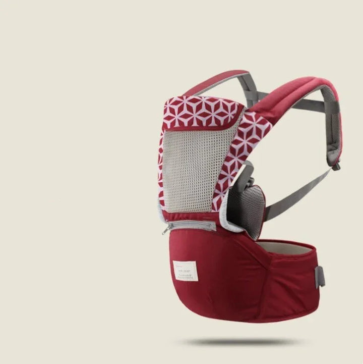 Red and white patterned ergonomic baby carrier with padded straps and mesh back support
